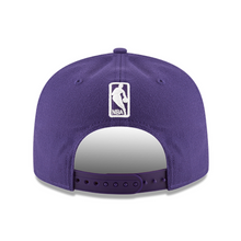 Load image into Gallery viewer, A purple structured baseball cap shown from the back, featuring a white NBA logo patch on the back panel and a matching purple adjustable strap.