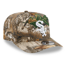 Load image into Gallery viewer, A baseball cap featuring a Realtree Max-7 camouflage pattern in shades of brown, beige, and green, with a white embroidered Chicago White Sox logo on the front.