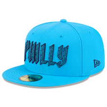 Load image into Gallery viewer, A bright blue fitted baseball cap with 'PHILLY' embroidered in black across the front, a small black New Era logo on the side, and a metallic gold sticker on the brim.