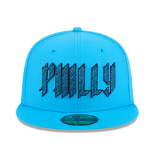 Load image into Gallery viewer, A bright blue fitted baseball cap with 'PHILLY' embroidered in a stylized black and blue font across the front. A green oval New Era 59Fifty sticker is visible on the brim.