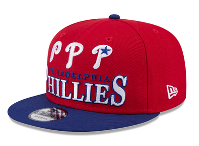 Red and blue Philadelphia Phillies cap on a red background and with a blue visor.