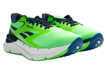Load image into Gallery viewer, Green running shoes with blue soles on 