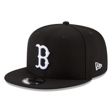 Load image into Gallery viewer, Black and white snapback baseball cap with embroidered eyelets and the Boston Red Sox logo on the front.