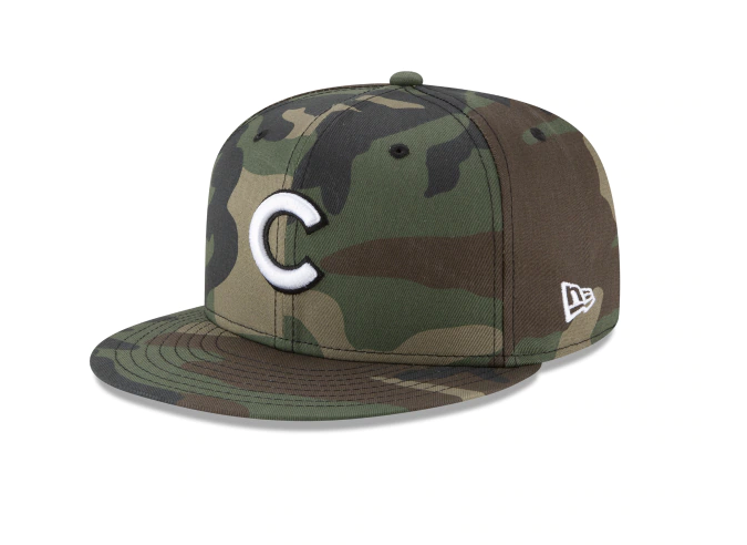 A camouflage-patterned fitted cap with embroidered eyelets, featuring the letters 'C' and 'Cubs' on the front.